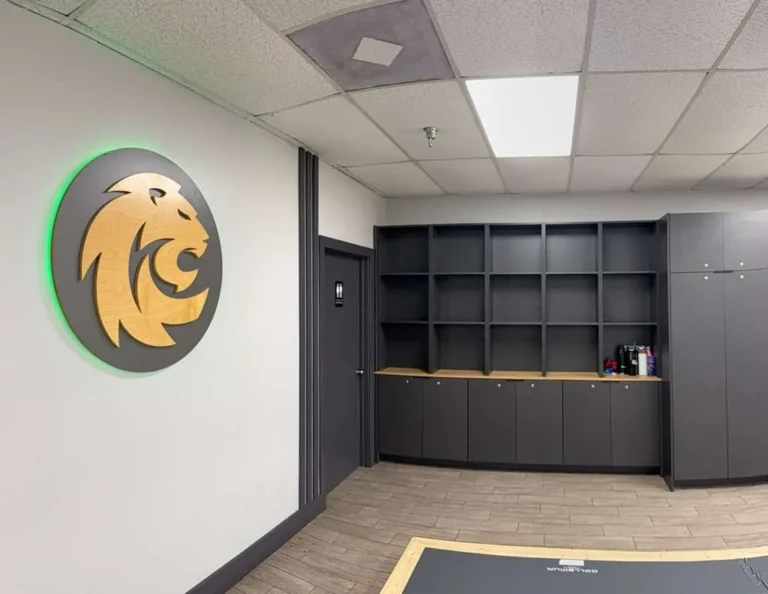 Changing room and personal storage amenities at Ceconi BJJ Cypress. Ceconi academy locker room with storage shelves and the lion emblem